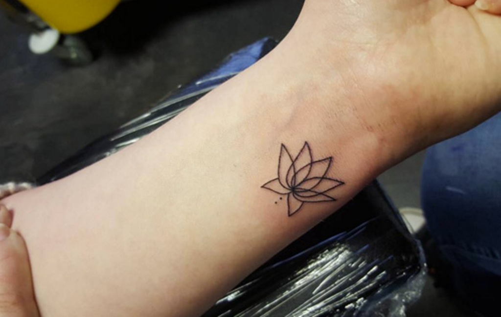 small lotus flower tattoo on foot